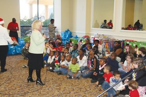 Special Photo: Anita Hammer tells a children’s story about Christmas to youngsters during the Annual Community Christmas Program at Community Bible Fellowship in Hampton.